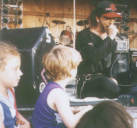 Steve sitting with young fans